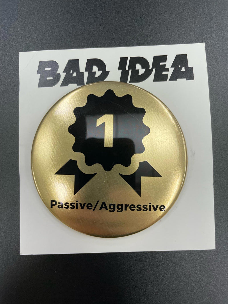 BAD IDEA GOLD FIRST CUSTOMER PROMO PIN - PASSIVE/AGGRESSIVE